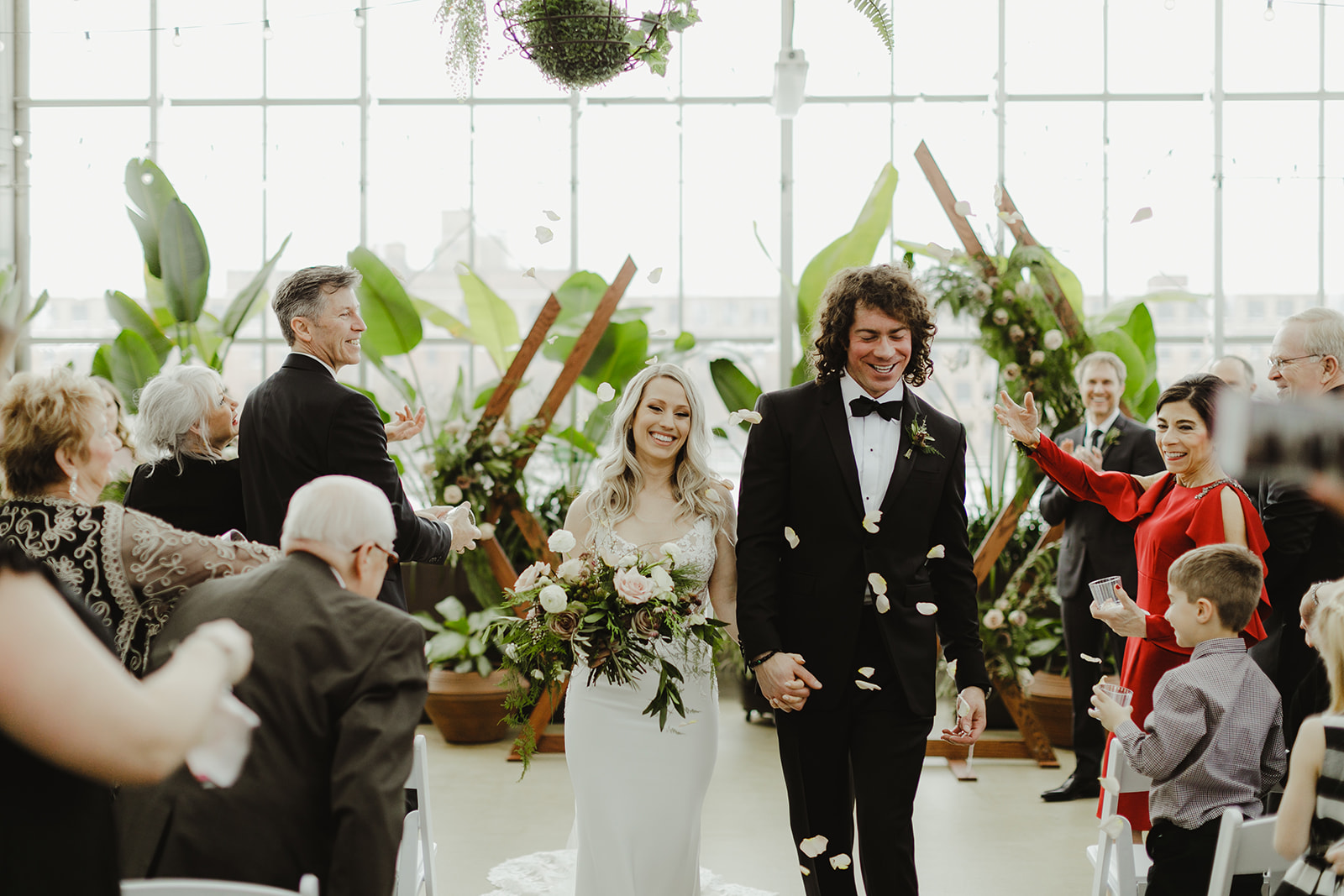A couple walking down the aisle during their Downtown Market Grand Rapids wedding 