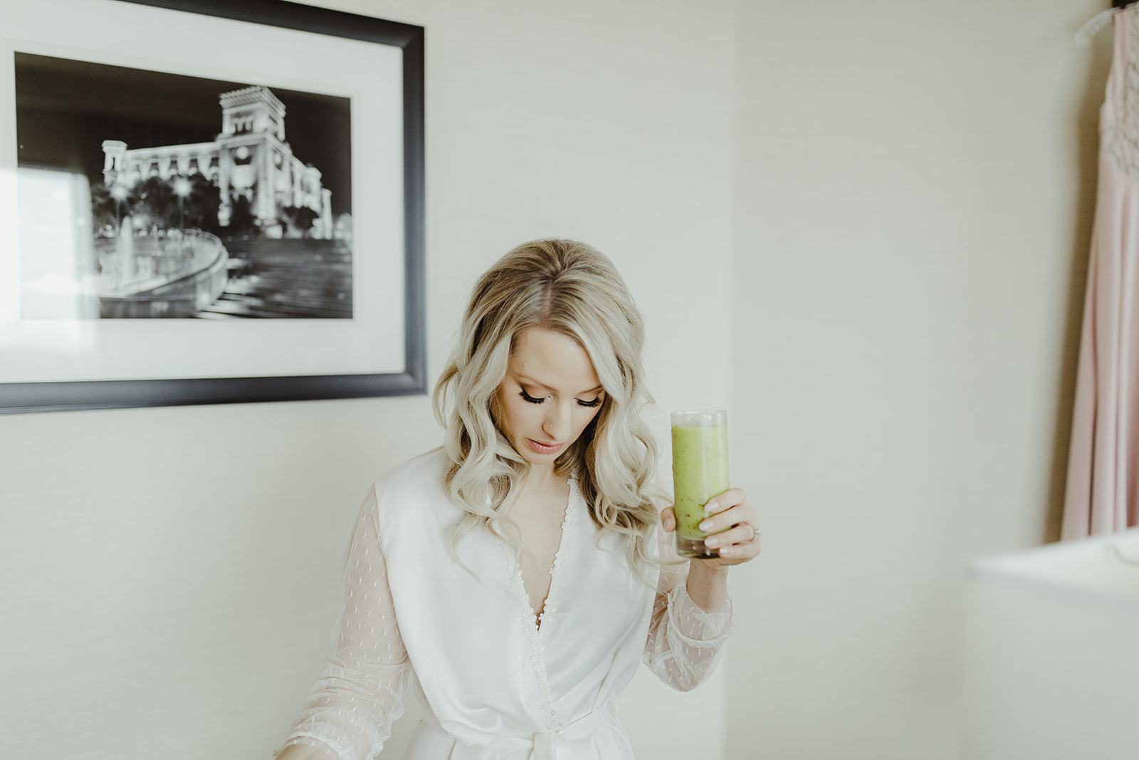 A bride getting ready for her wedding day with a green juice