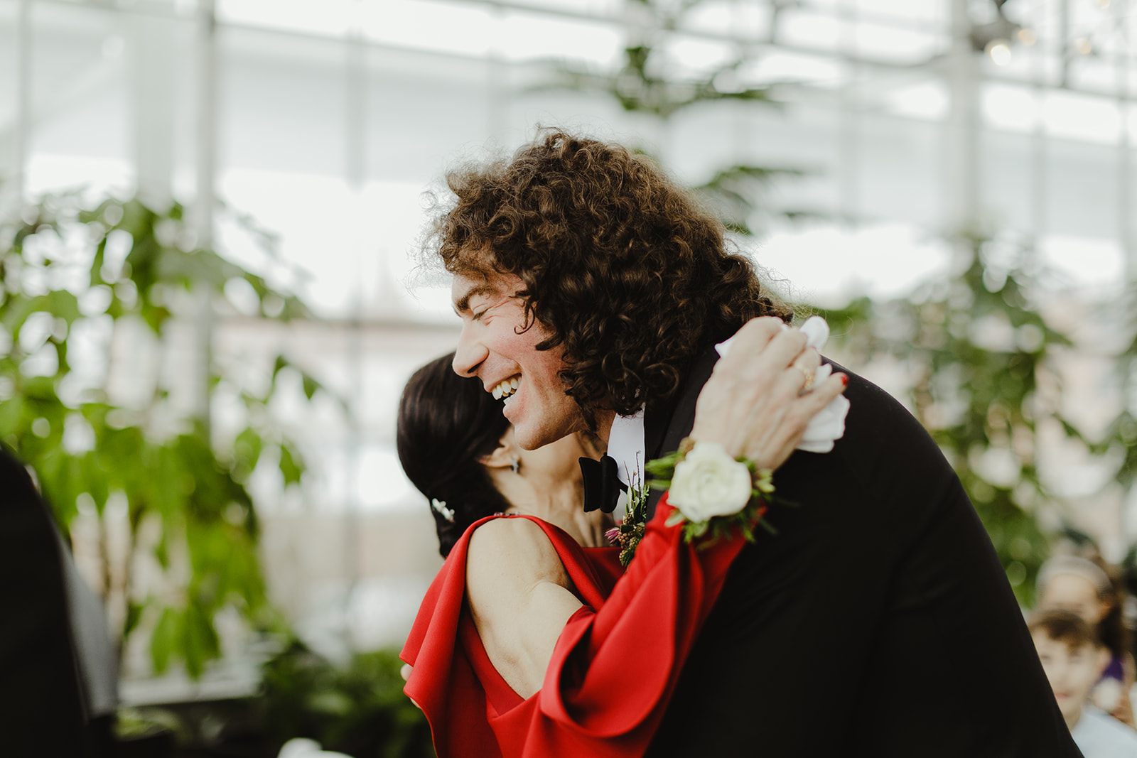 A groom hugging his mom on his wedding day