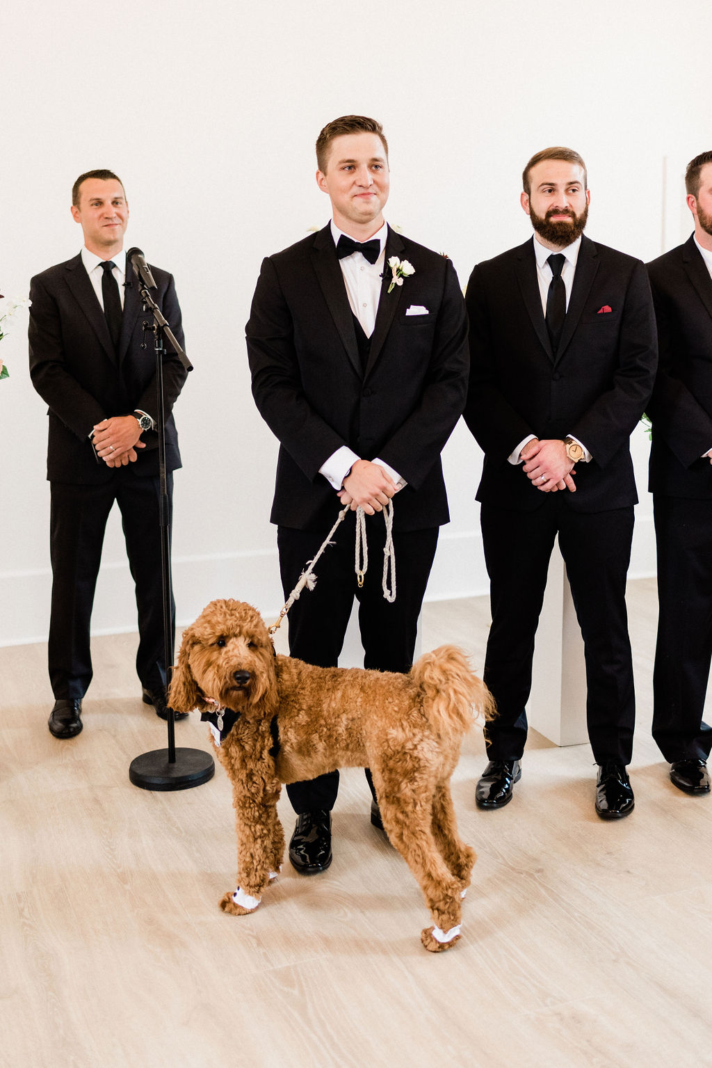 A groom smiling with his dog