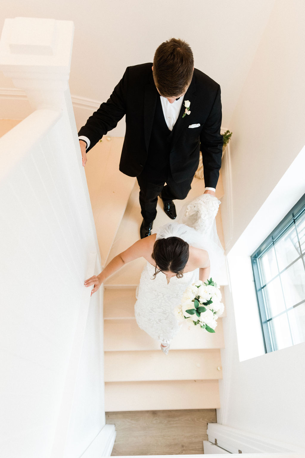 Couple walking down the stairs after their wedding at the Loft 310 Chapel