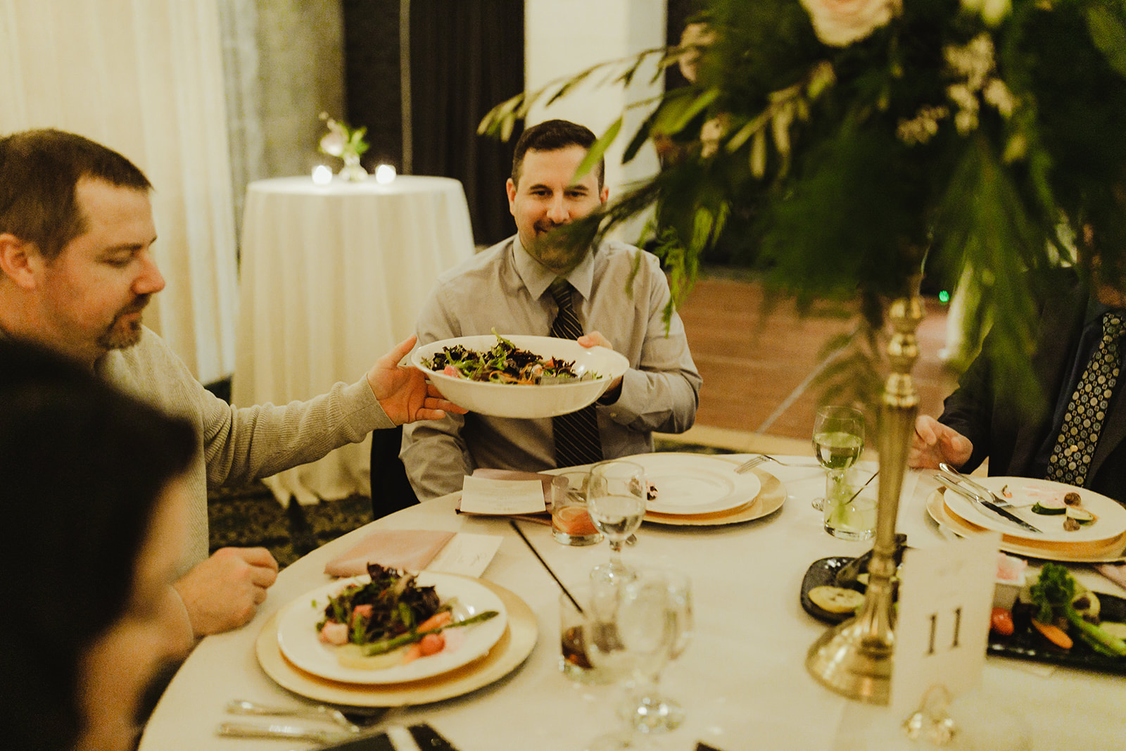 Guests passing around a plate of food during a Grand Rapids, Michigan wedding