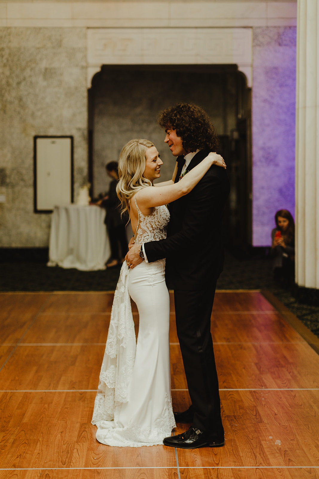 A couple smiling and dancing on their wedding day