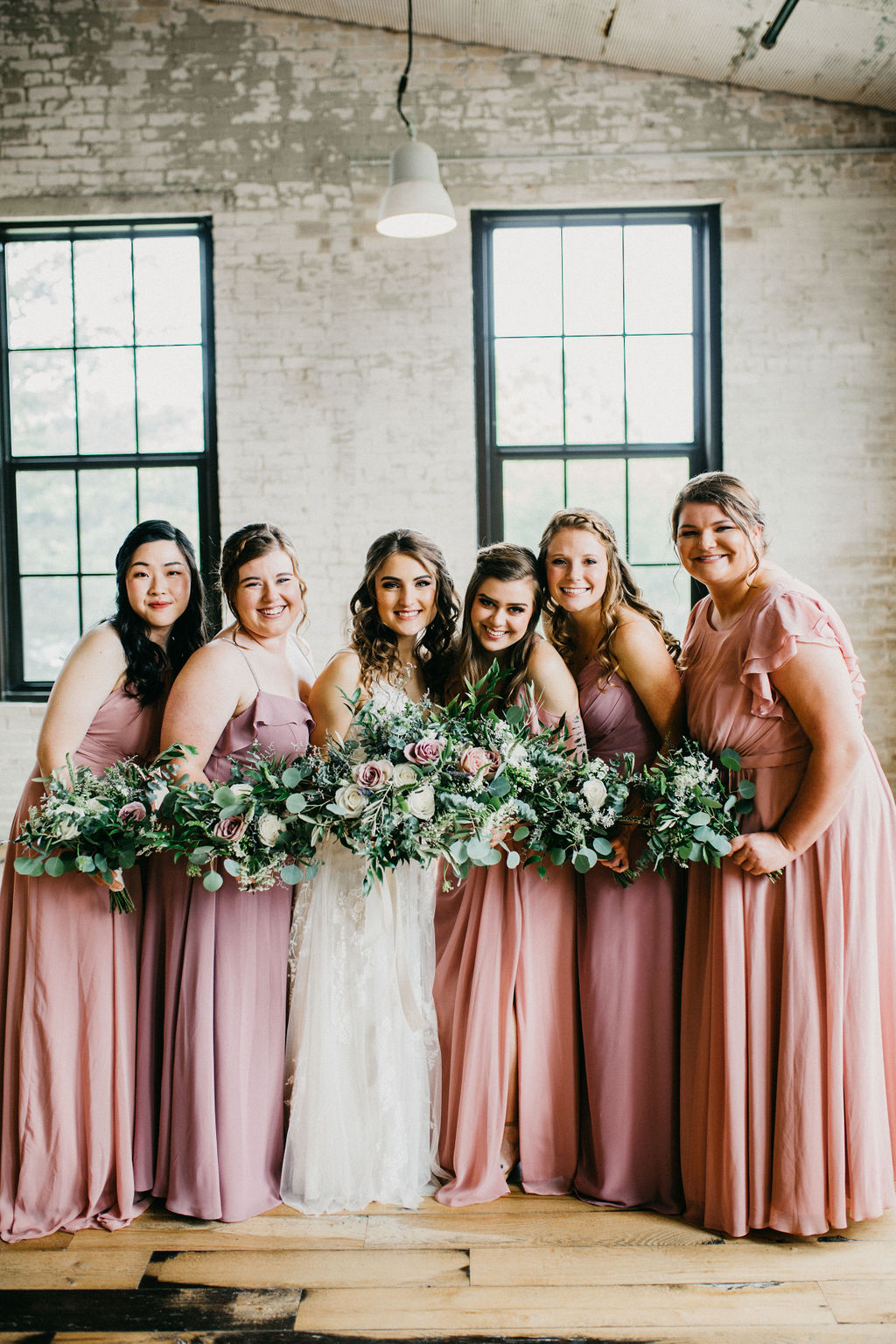 Bride and bridesmaids smiling