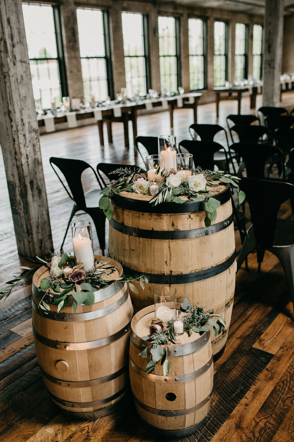 Whiskey barrels set with flowers and candles 