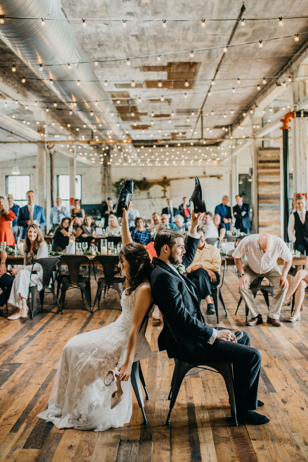 A couple playing the shoe game at their wedding