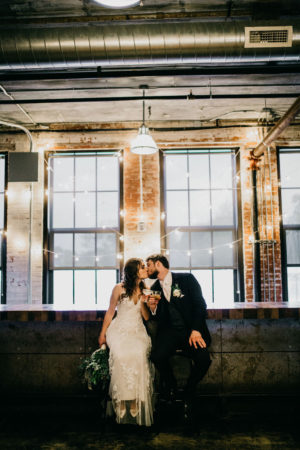 A couple kissing during their Journeyman Distillery wedding