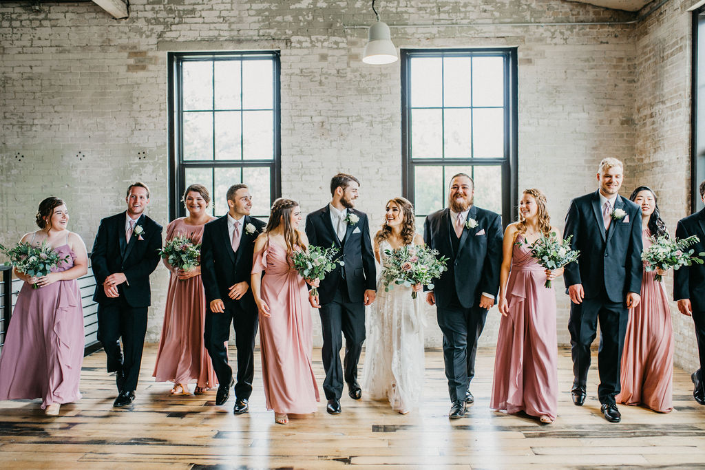 Bridesmaids and groomsmen smiling 