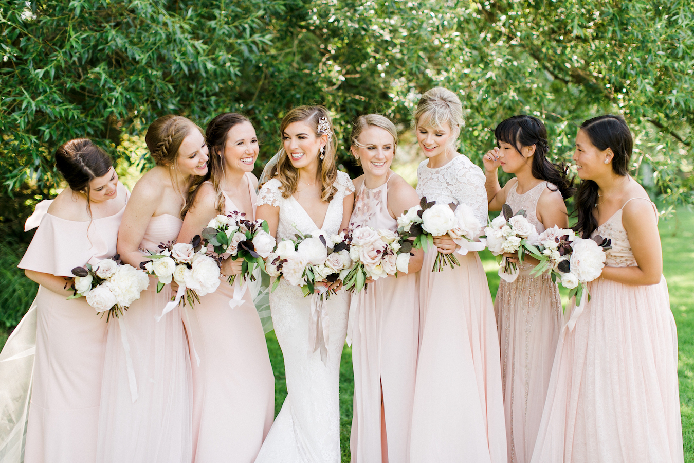 A bride and her bridesmaids smiling 
