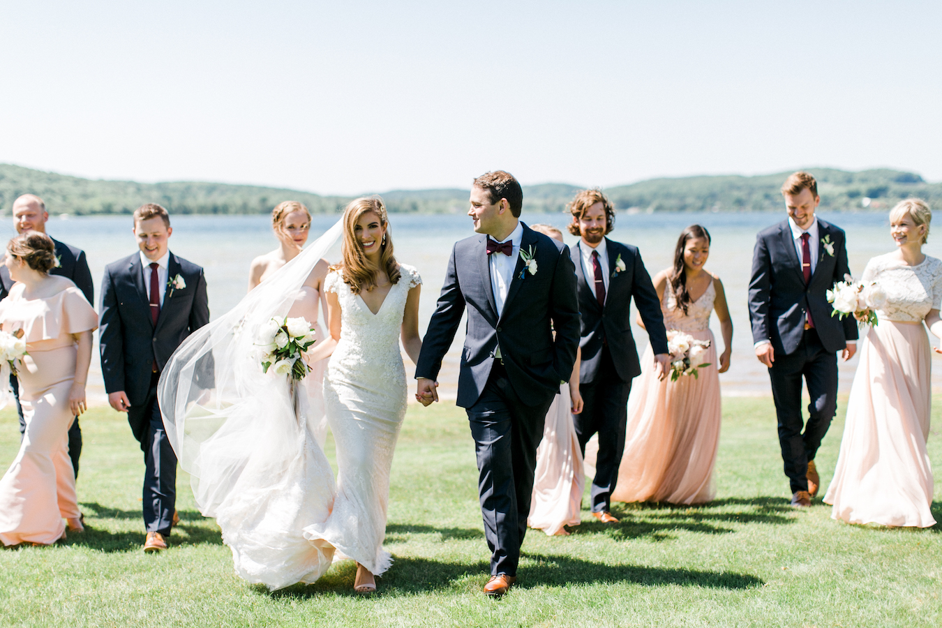 A wedding party smiling at Deer Lake, Michigan