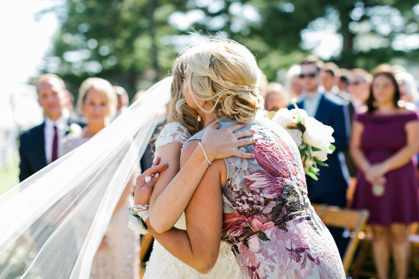 A bride hugging her mother 