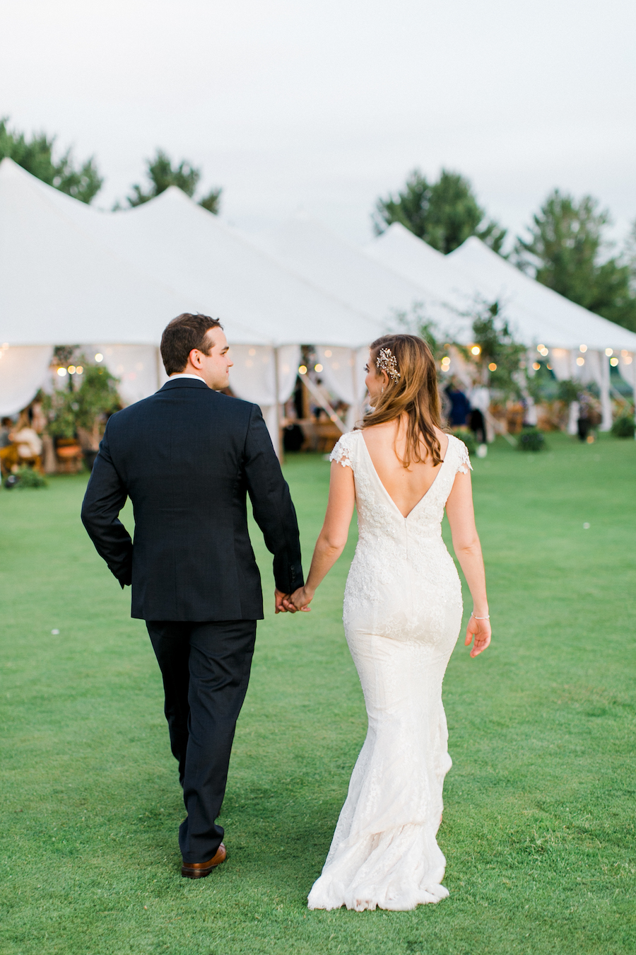 A couple walking back to their tent during their Boyne Mountain Resort wedding
