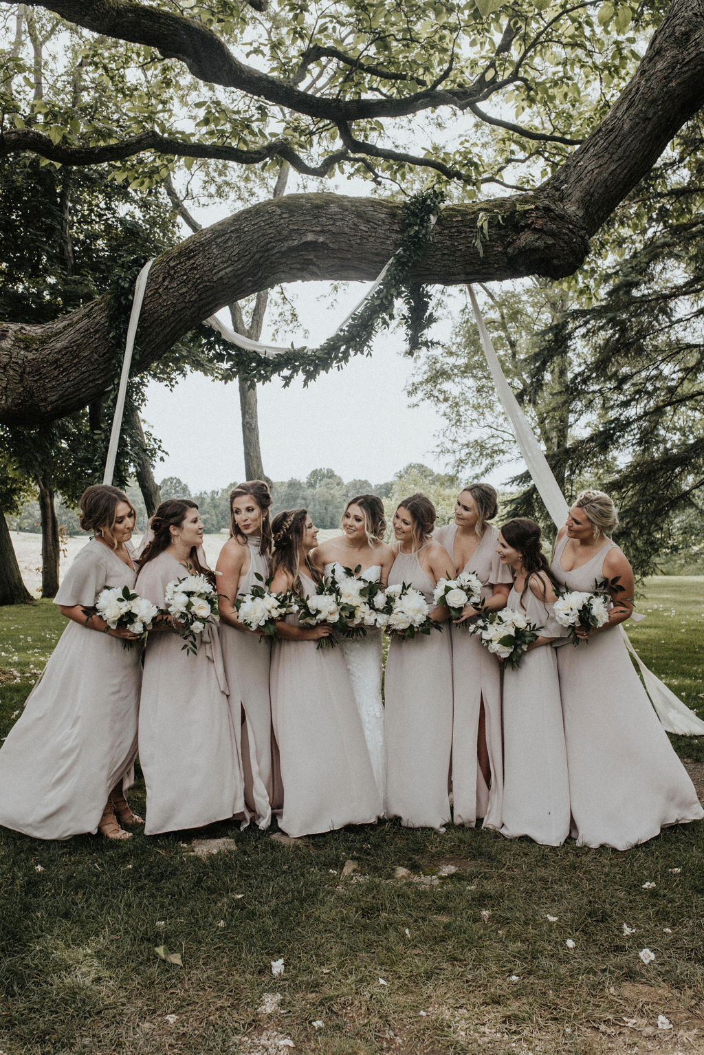 A bride and her bridesmaids smiling