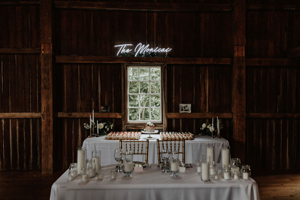 A sweetheart table set for a barn wedding