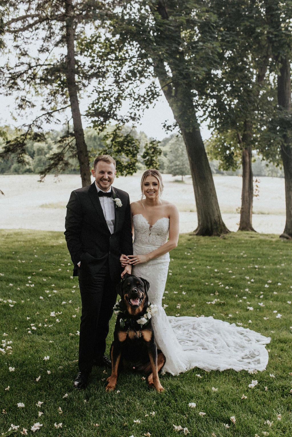 A couple smiling with their dog after their Berrien Springs, Michigan wedding