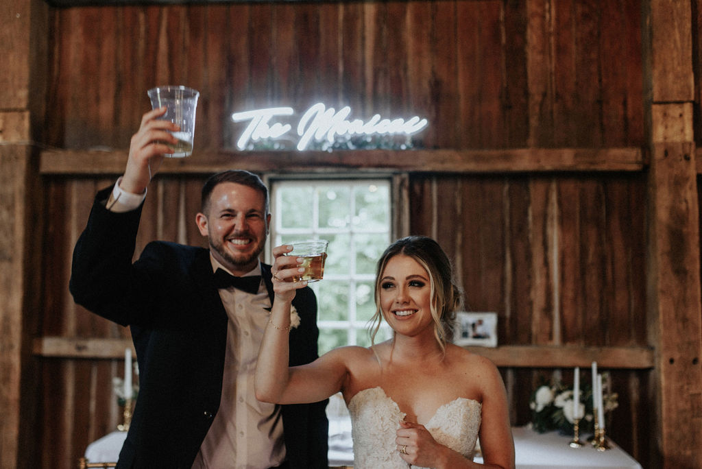 A couple toasting their guests