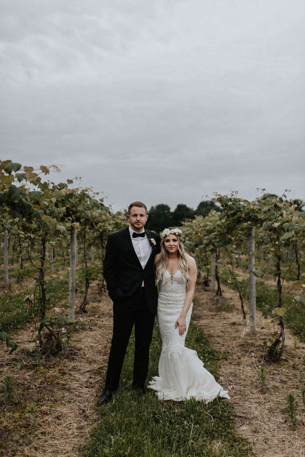 A couple smiling in the vineyards
