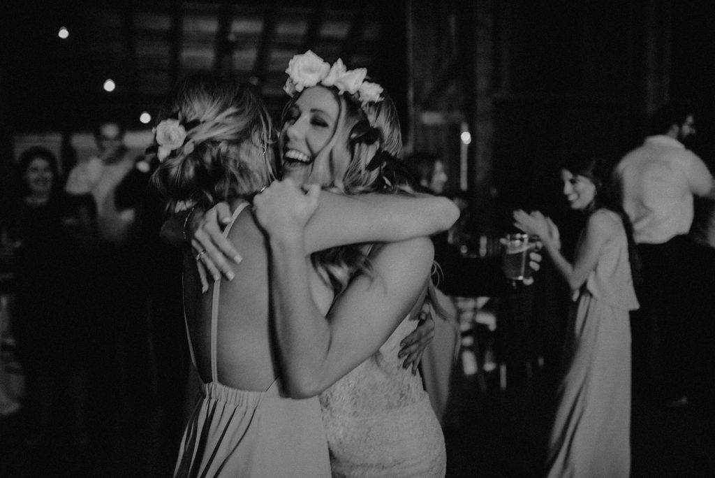 A bride and her sister dancing