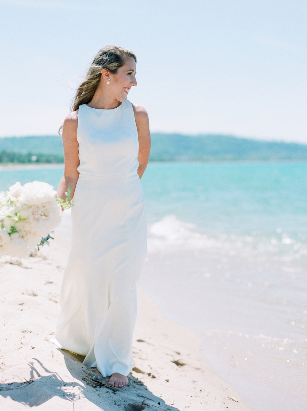 A bride smiling on the beach