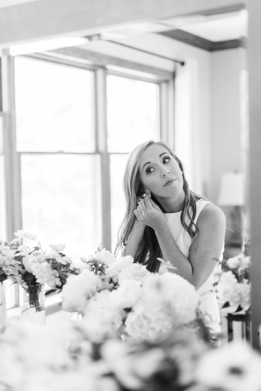 A bride putting on her earrings