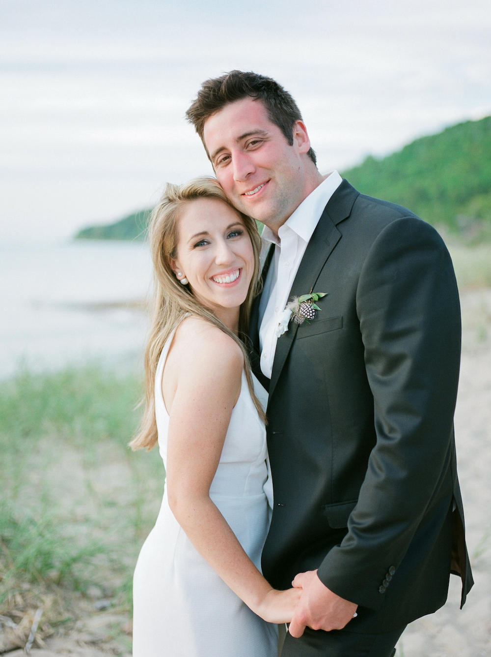 A couple smiling on the beach in Glen Arbor, Michigan