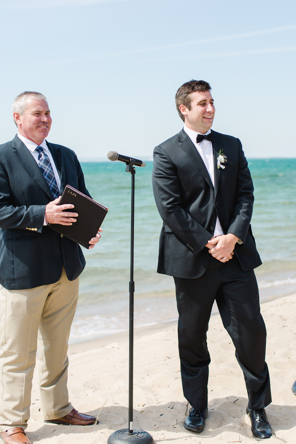 A groom smiling at his bride