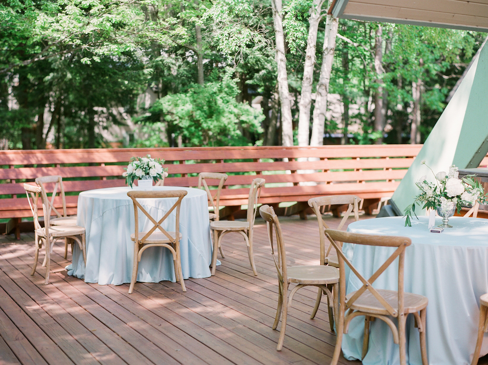 Light blue tables on a deck during a Leelanau school wedding