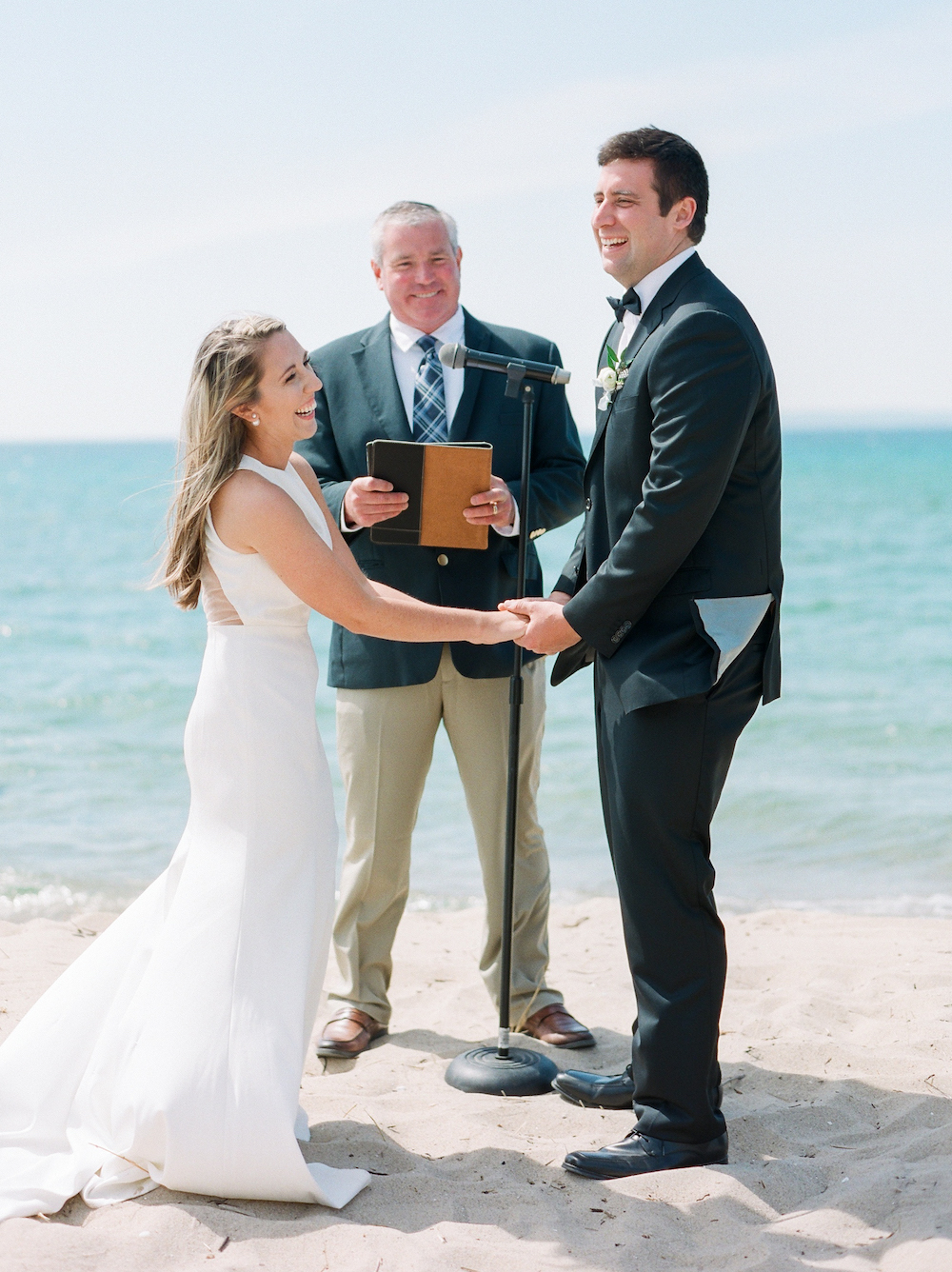 A couple smiling during their lake Michigan wedding