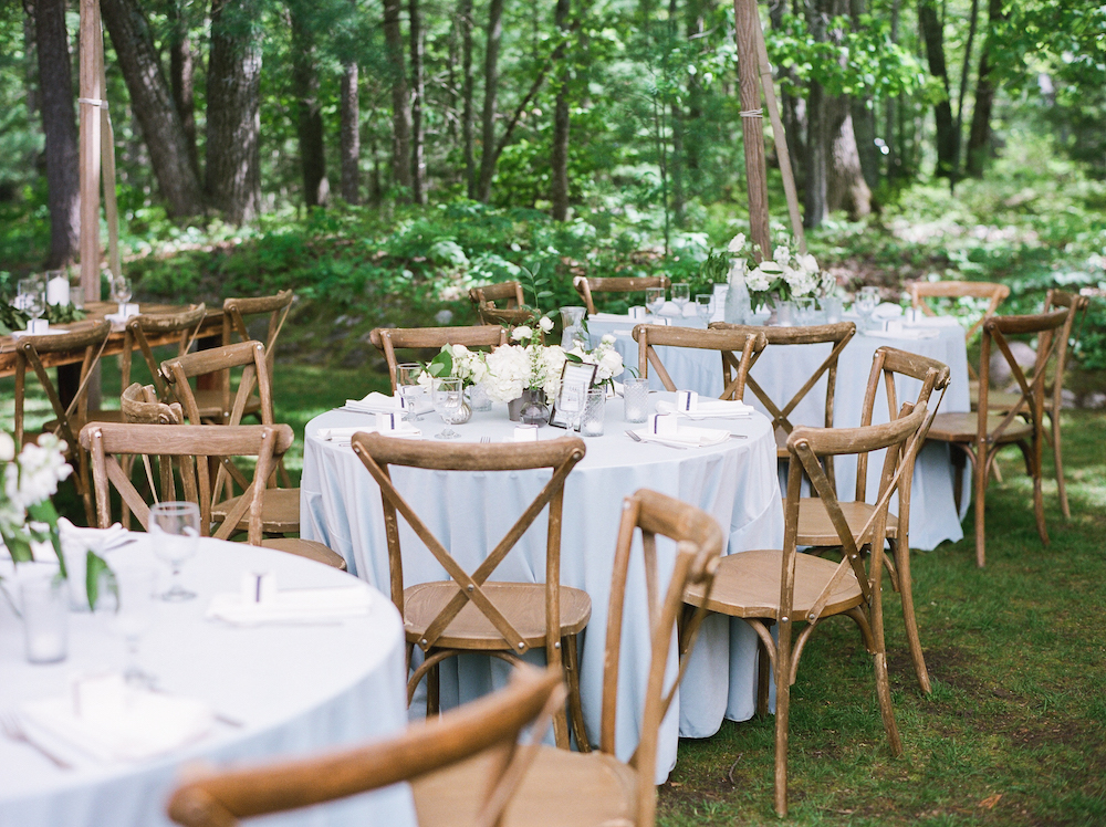 Tables set for a wedding in the woods