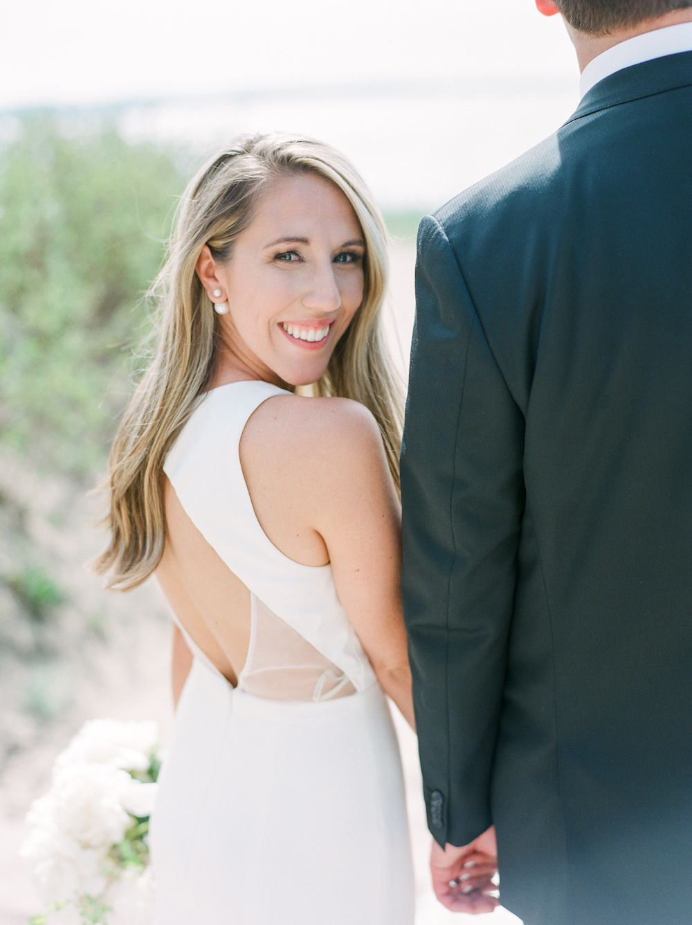 A bride smiling during her lake michigan wedding