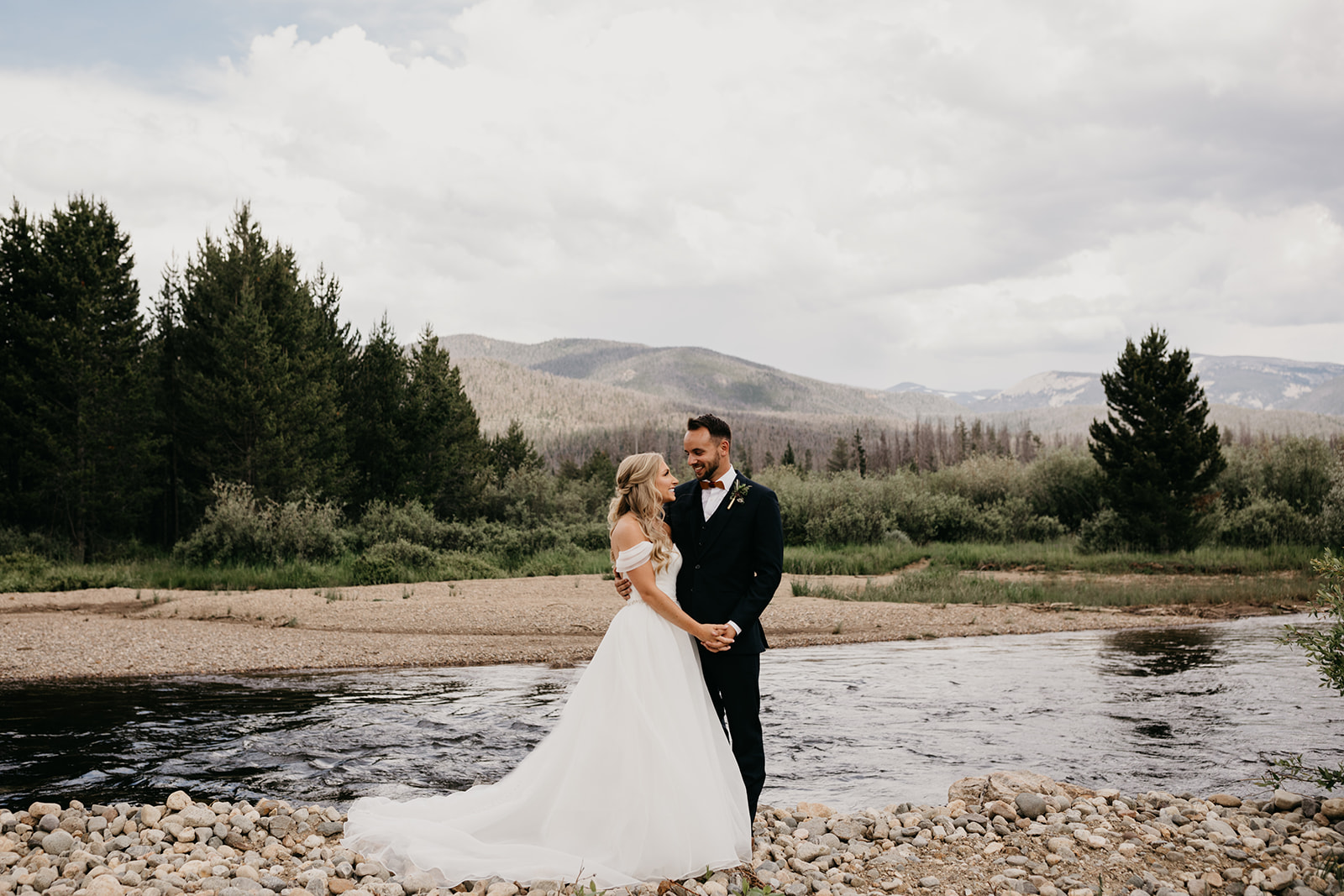 Couple smiling before their Rocky Mountain wedding