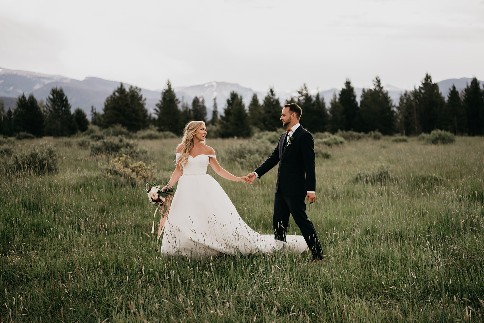 A couple smiling after their mountain wedding