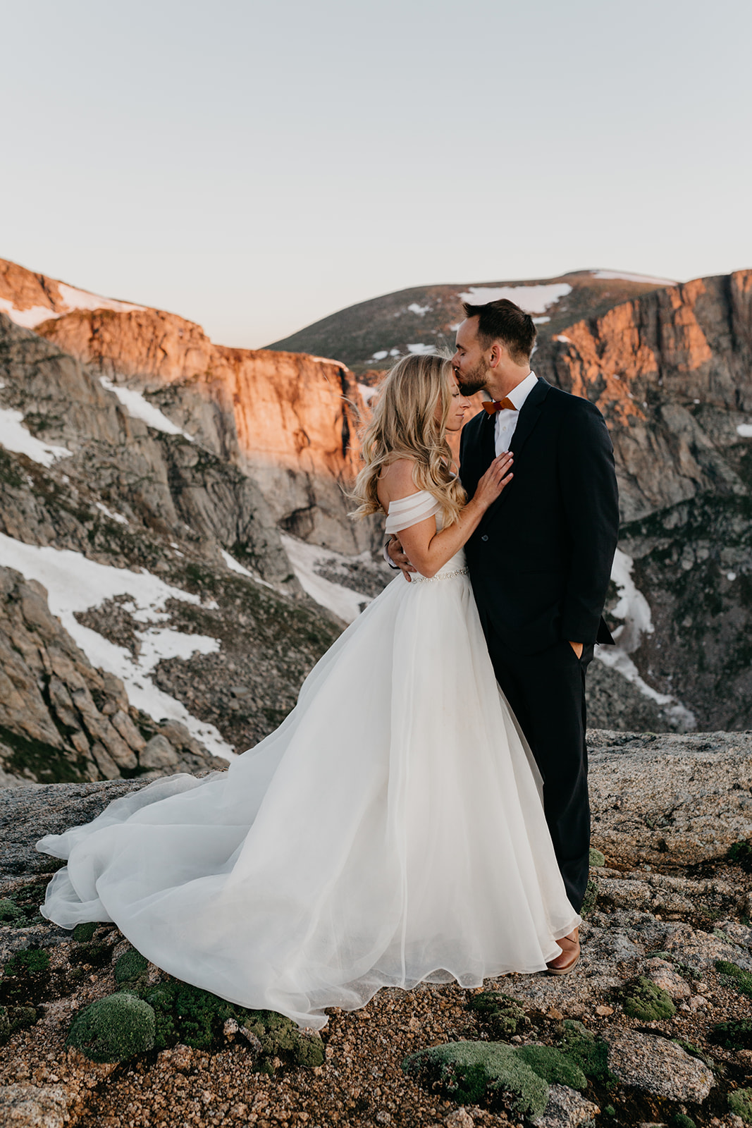 Bride and groom kissing at their rocky mountain wedding