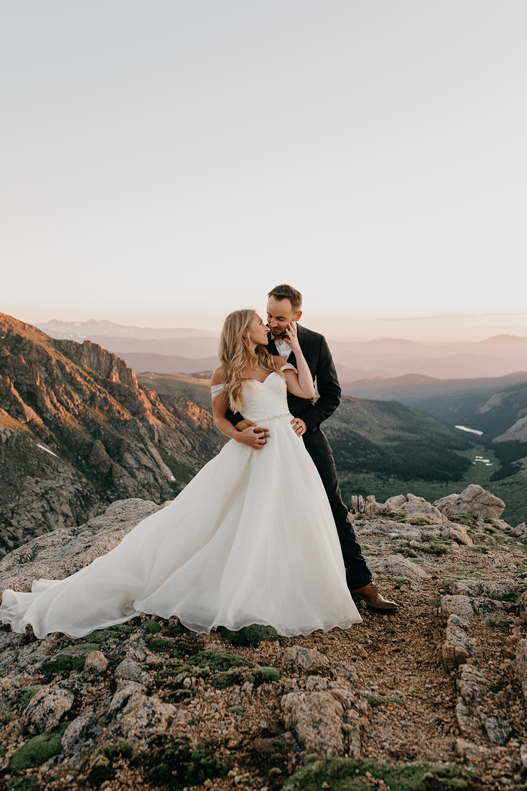 Couple kissing during sunset during their rocky mountain wedding