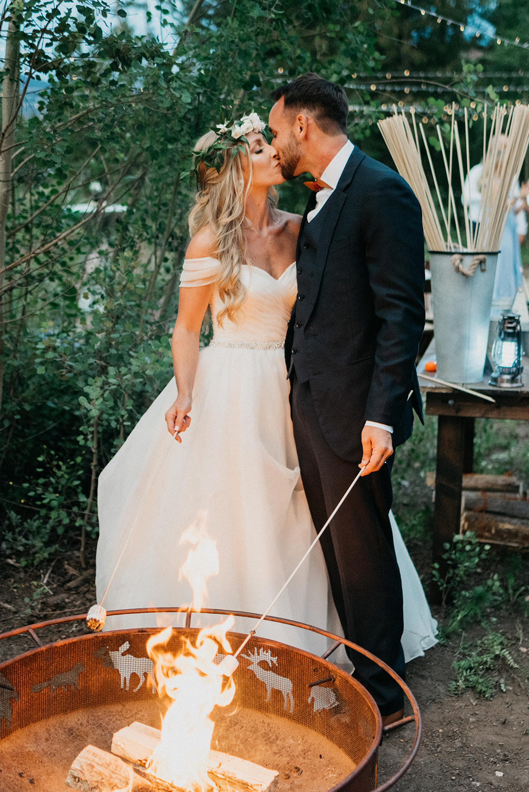 Couple roasting smores at their wedding