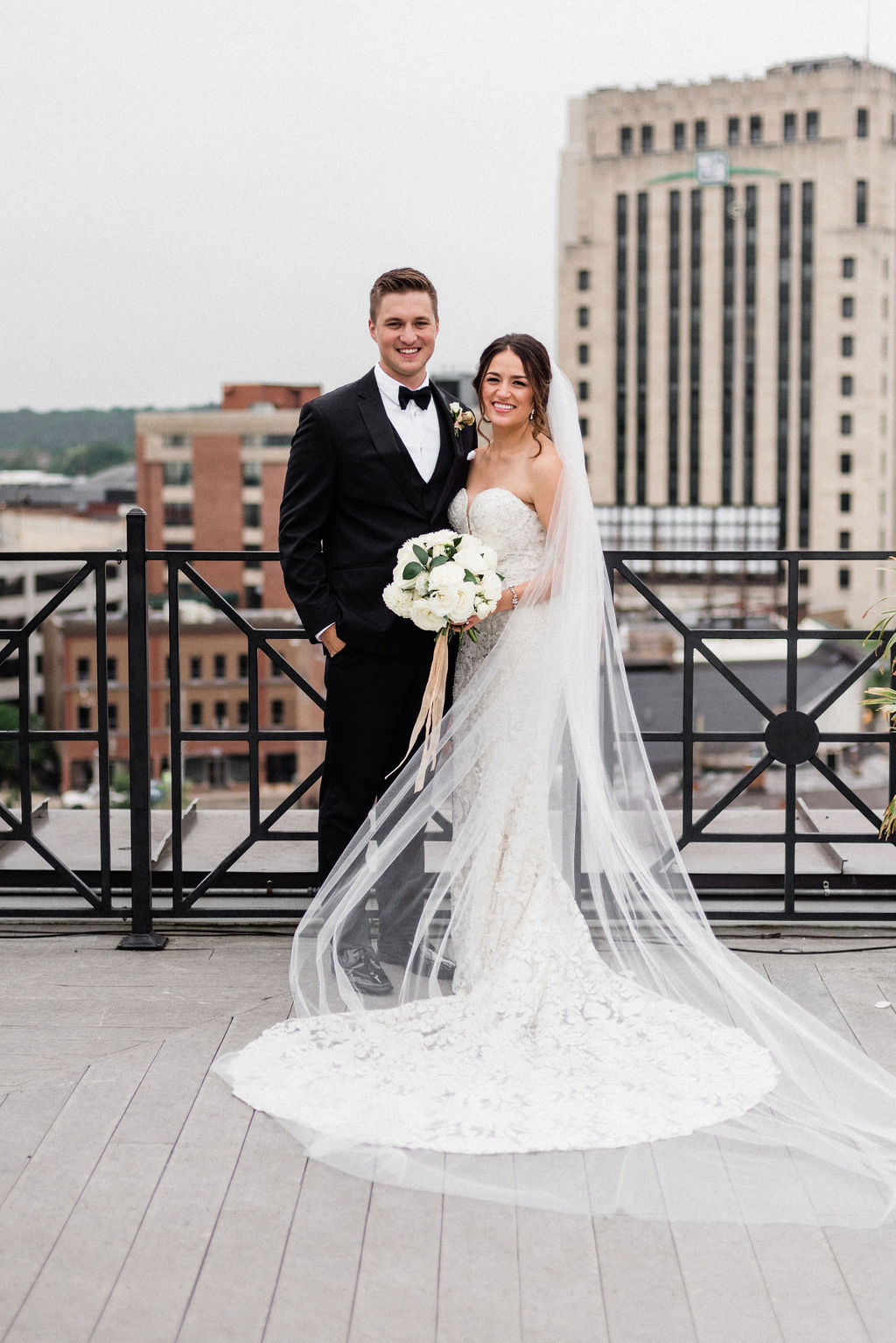 A bride and groom smiling during their downtown kalamazoo wedding