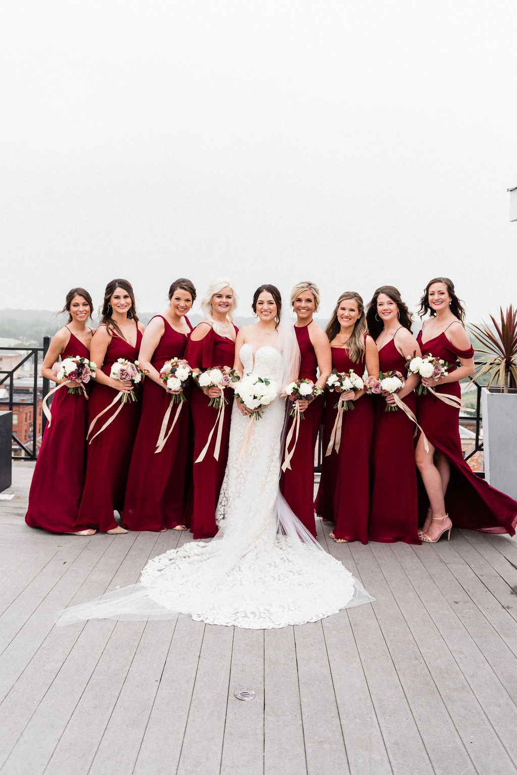 A bride and her bridesmaids smiling before her wedding