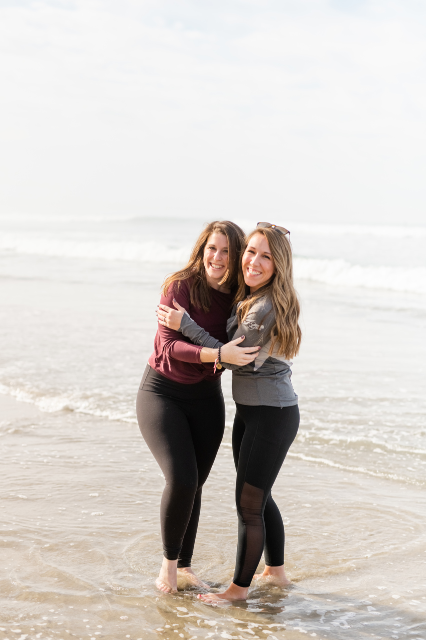Two girls hugging at Beacons Beach in Encinitas, CA