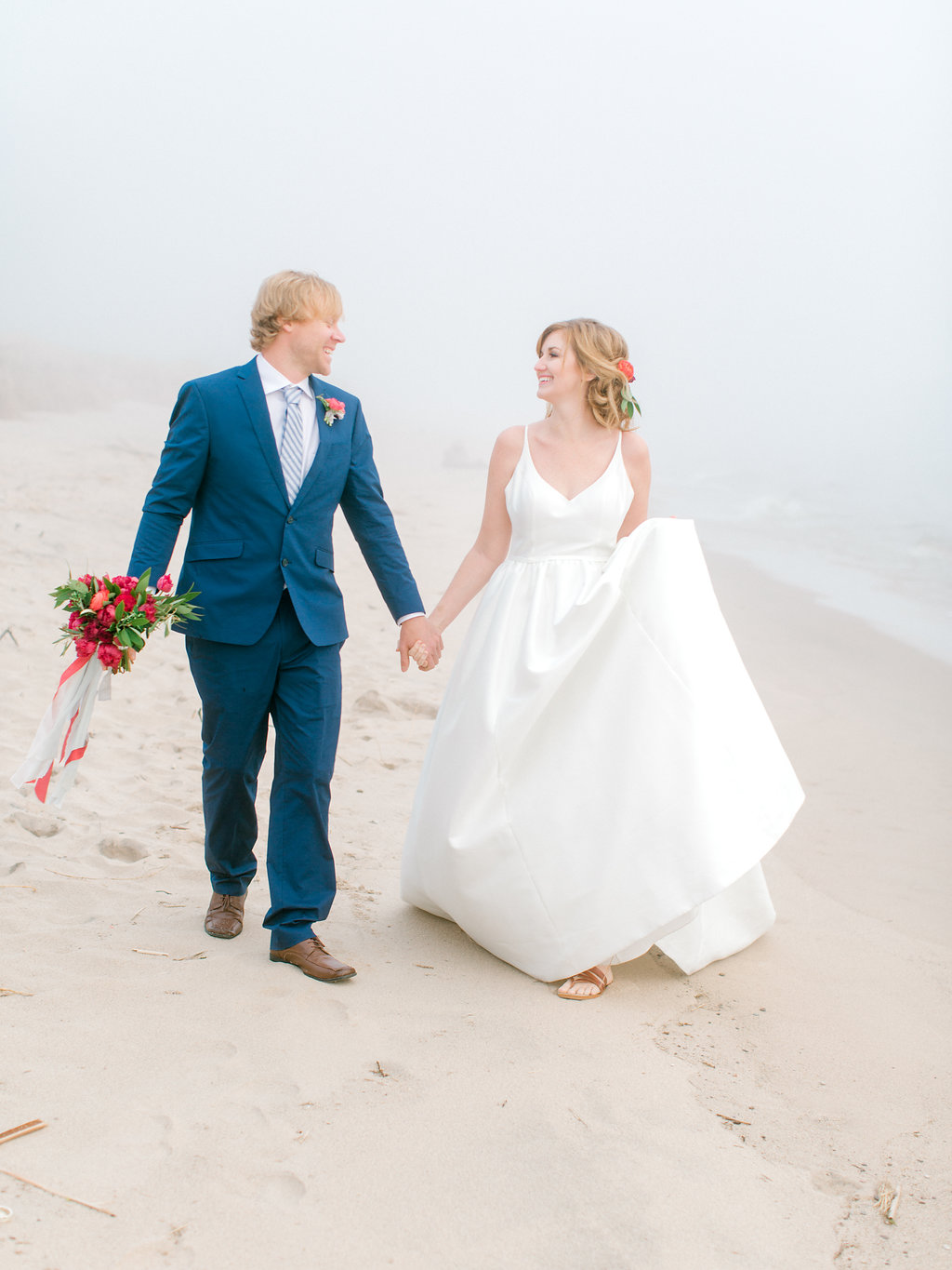 Couple walking down the beach during their Lake Michigan wedding