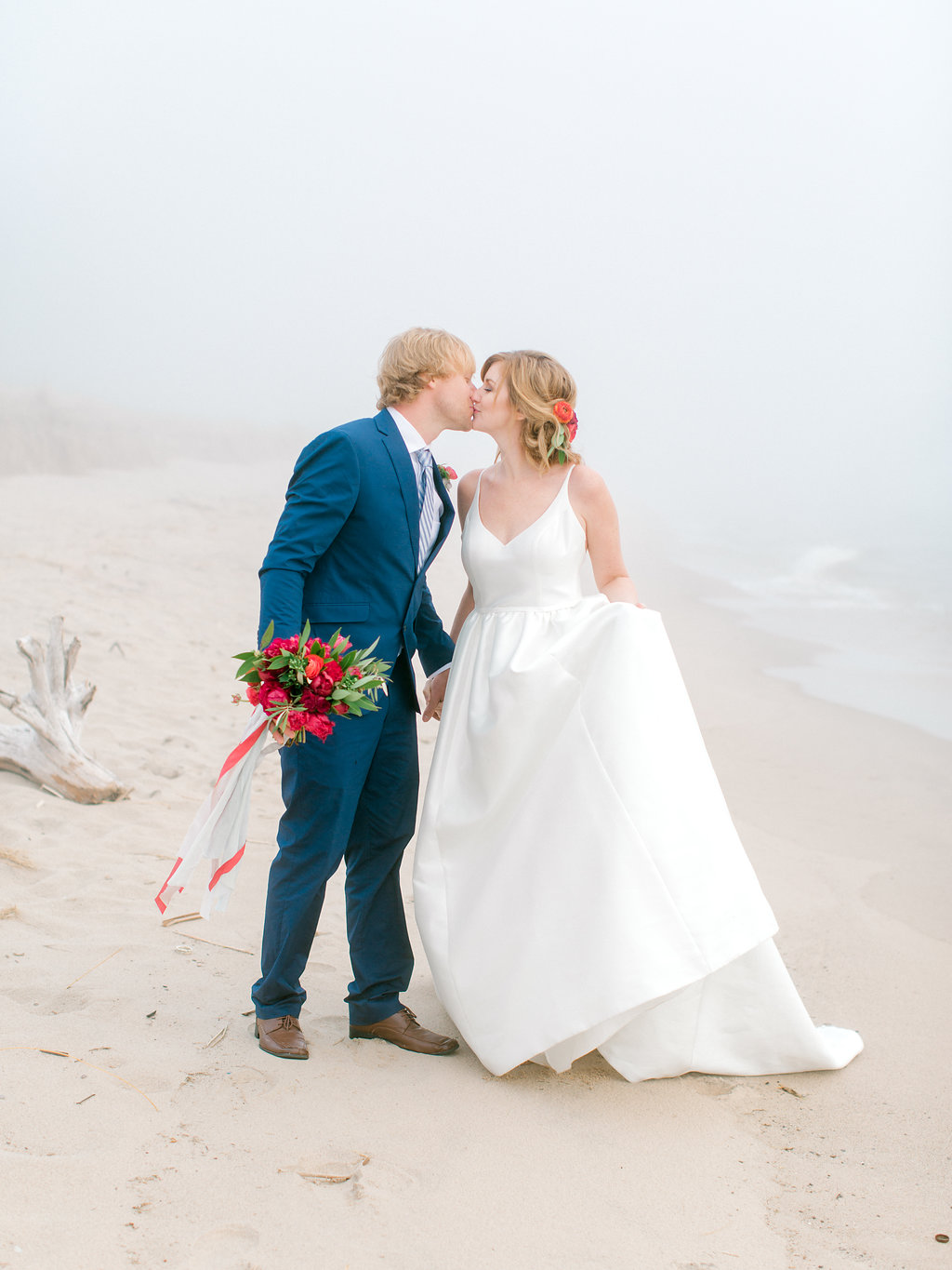 Couple kissing during their Lake Michigan wedding at Camp Blodgett