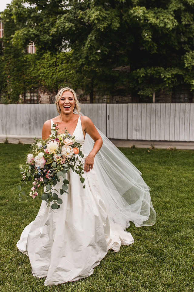 Bride smiling holding her bouquet 