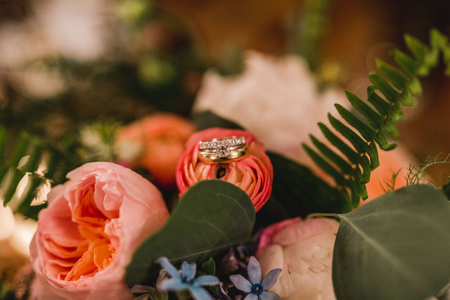 Rings sitting on flower of bouquet 