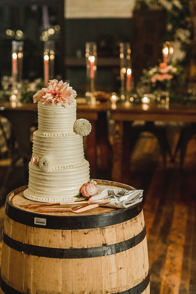 Wedding cake sitting on barrel at Southwest Michigan wedding venue
