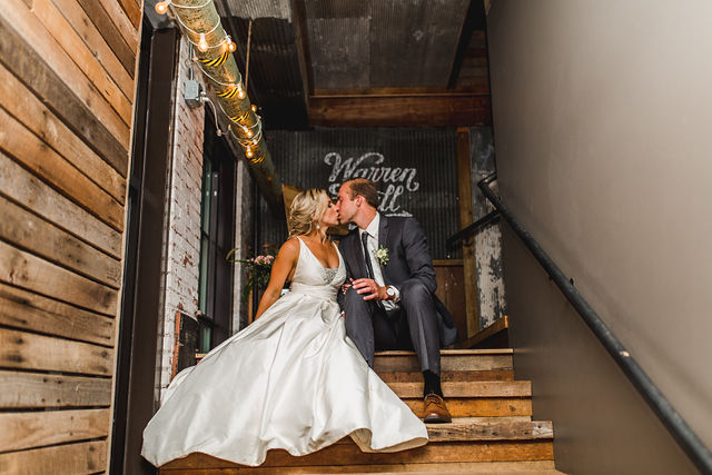 Bride and groom kissing in stairway of Southwest Michigan wedding venue