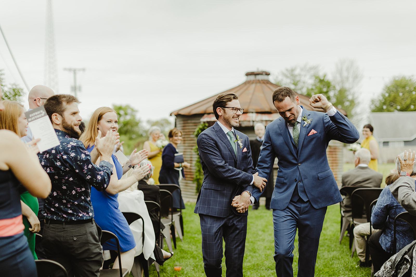 Grooms celebrating after their Journeyman Distillery wedding