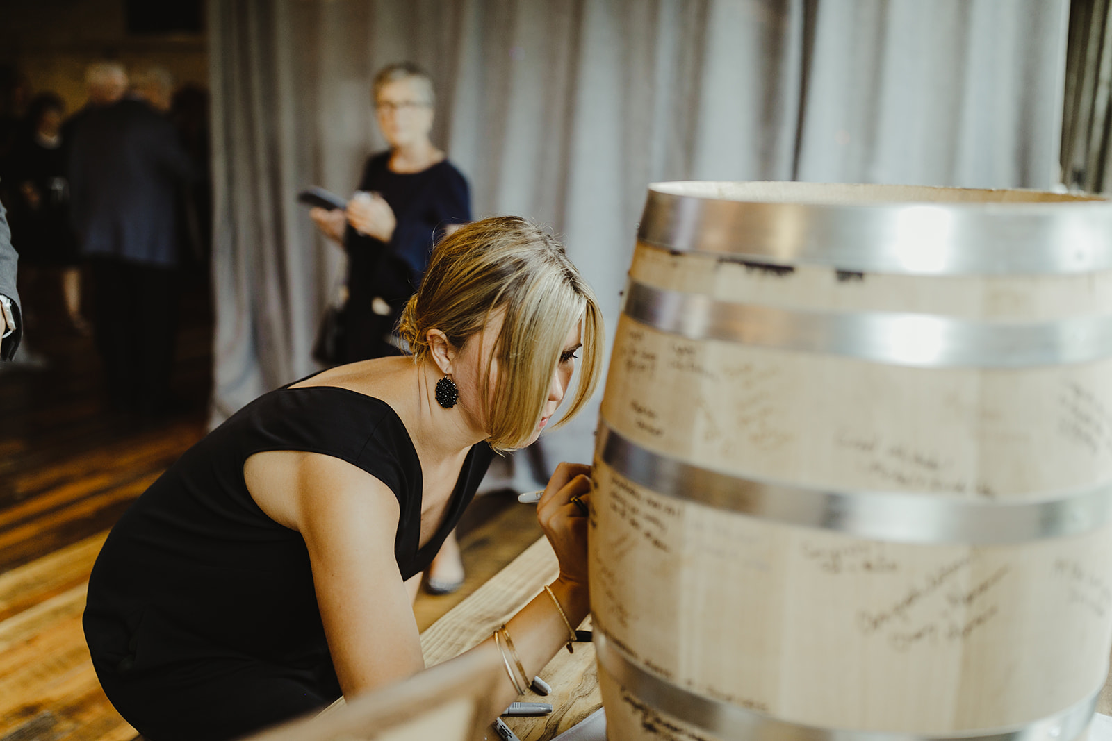 Guests signing a barrel guest book