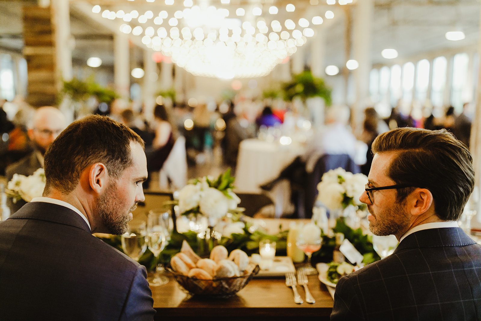 Grooms enjoying their Journeyman Distillery wedding reception