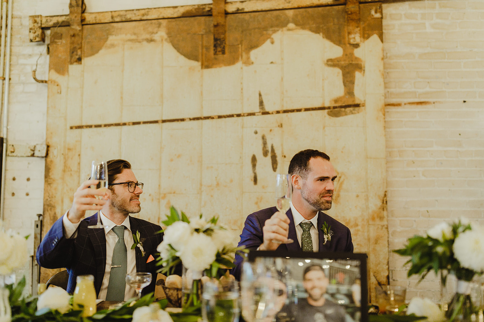 Grooms toasting their friends