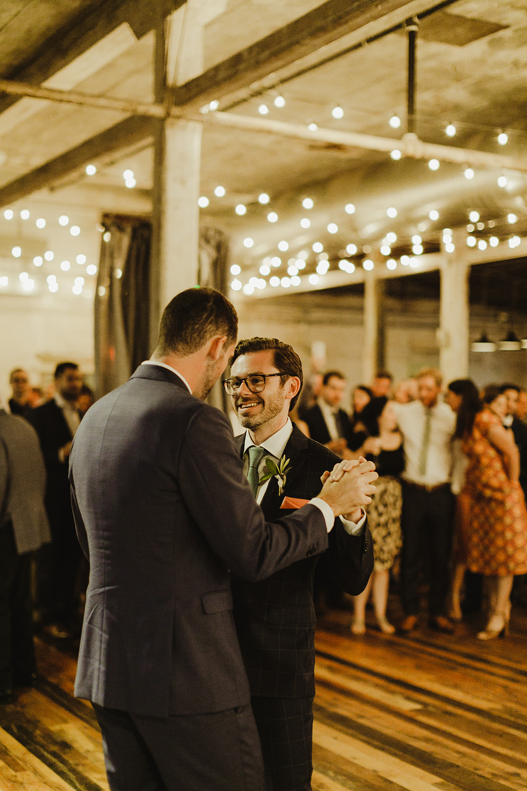 Grooms sharing their first dance