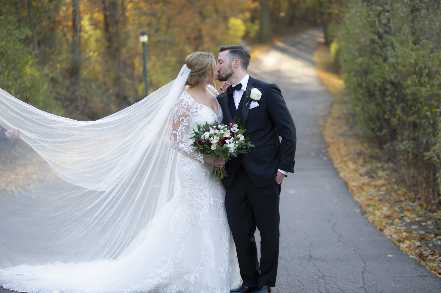 Bride and groom kissing at rustic Michigan wedding